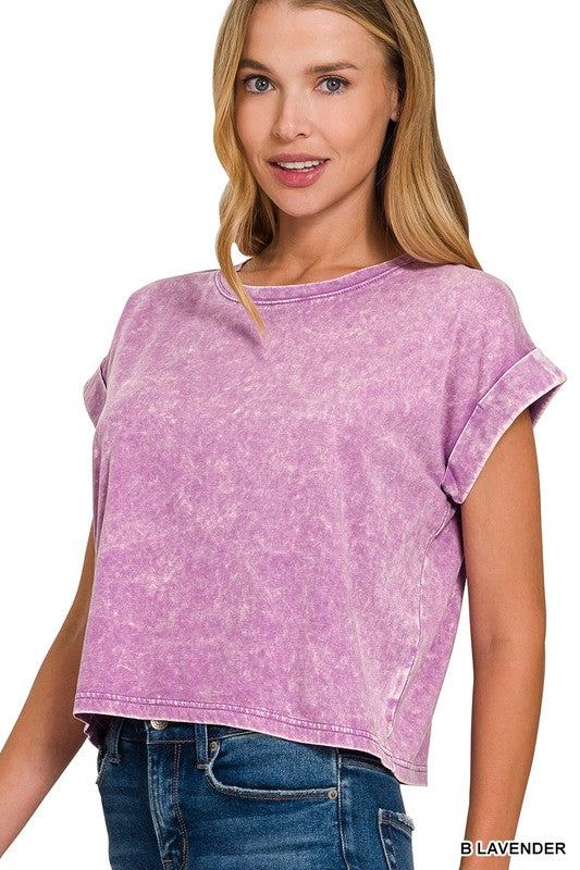 A woman wearing a lavender acid wash cotton folded sleeve top with jeans.
