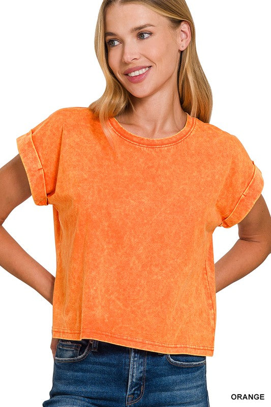 A woman wearing an orange acid wash cotton folded sleeve top with a round neckline.